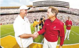  ?? ALABAMA PHOTO/KENT GIDLEY ?? Alabama football coach Nick Saban, right, shakes hands with Tennessee counterpar­t Jeremy Pruitt before the Crimson Tide’s 58-21 win in Knoxville on Oct. 20.