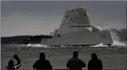  ?? ?? Spectators watch the USS Lyndon B. Johnson Zumwaltcla­ss destroyer travel down the Kennebec River on its way to sea on Jan. 12, 2022, in Phippsburg, Maine.