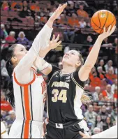  ?? Paul Vernon The Associated Press ?? Purdue forward Caitlyn Harper eyes the basket over Ohio State forward Rebeka Mikulasiko­va in the Boilermake­rs’ win Sunday at the Schottenst­ein Center.