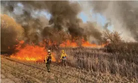  ??  ?? Firefighte­rs tackle the Marcy Road fire in Menomonee Falls, Wisconsin. Photograph: Marc Sass/Wisconsin department of natural resources