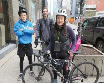  ?? TORONTO STAR ?? UberEats changed the compensati­on structure of its delivery people, affecting its cyclist contractor­s. Couriers, from left, Brett MacNeill, Mike Dalton and Julia Pak were protesting outside Uber’s Toronto office.