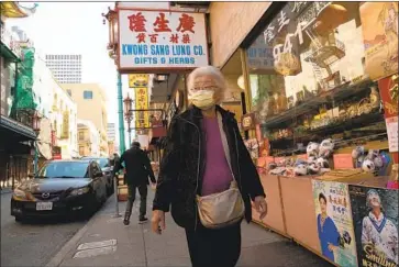  ?? John G. Mabanglo EPA/Shuttersto­ck ?? A WOMAN wears a mask Wednesday in San Francisco. A new Northern California coronaviru­s case that could be the first instance of “community spread” in the U.S. was reportedly caught by UC Davis physicians.