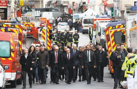  ?? Pierre Suu / Getty Images ?? French Interior Minister Bernard Cazeneuve visits the Rue de la Republique in St.-Denis, near the site of the raid.