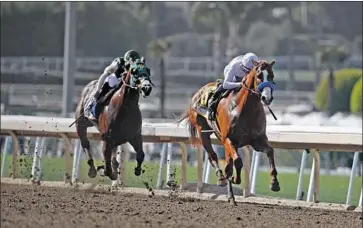  ?? Jae C. Hong Associated Press ?? JUSTIFY, who went wire to wire under Mike Smith, pulls away from Bolt d’Oro and Javier Castellano down the stretch in the Santa Anita Derby. There probably will be a rematch in the Kentucky Derby next month.