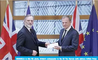  ?? —AFP ?? BRUSSELS: In this file photo, Britain’s ambassador to the EU Tim Barrow (left) delivers British Prime Minister Theresa May’s formal notice of the UK’s intention to leave the bloc on March 29, 2017. The European Court of Justice ruled yesterday that Britain could halt withdrawal from the EU without seeking the approval of fellow member states, in a victory for anti-Brexit campaigner­s.