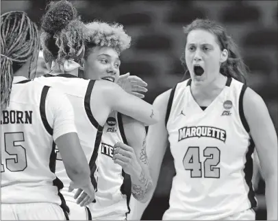  ?? [DAVID J. PHILLIP/THE ASSOCIATED PRESS] ?? Marquette’s Natisha Hiedeman, center right, is hugged by Selena Lott as teammates Lauren Van Kleunen and Amani Wilborn celebrate after Hiedeman’s free throws helped the Golden Eagles beat Rice in overtime of Friday’s NCAA Tournament game.