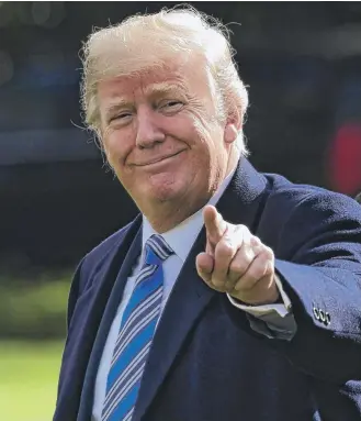  ?? SUSANWALSH/ AP ?? Nearly half of Americans surveyed — 47 percent — say they approve of how President Donald Trump is handling the economy, his highest rating on any issue.