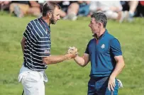  ?? ALASTAIR GRANT THE ASSOCIATED PRESS FILE PHOTO ?? Dustin Johnson, left, and Rory McIlroy will play in the first live golf on television since the pandemic shut down the sport.