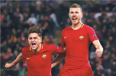  ?? MAX ROSSI / REUTERS ?? Roma’s Edin Dzeko celebrates with Cengiz Under after scoring against Shakhtar Donetsk in their Champions League round of 16 second-leg match at Rome’s Stadio Olimpico on Tuesday. Roma won 1-0 and advanced on away goals.