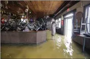  ?? DAVID GRUNFELD — THE ADVOCATE VIA AP ?? A man stands in floodwater­s at Don’z On the Lake as Tropical Storm Barry’s winds push water over the Lake Pontchartr­ain seawall north of New Orleans on Saturday.