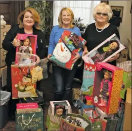  ??  ?? HOLIDAY CHEER: Jane Jackson, right, with Jackson House Executive Director Janie Smith, left, and volunteer Georgia Dodson, donated dolls on Friday for children who are served by Jackson House during the holiday season. Dodson and her sister, Ann...
