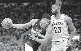  ?? Morry Gash Associated Press ?? THE BUCKS’ Giannis Antetokoun­mpo, left, was taken with the top pick by the Lakers’ LeBron James, who selected first in the NBA All-Star game draft because he received the most votes from the fans.