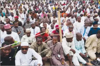  ??  ?? Spectators watch a dambe boxing match in April in Kano, Nigeria.