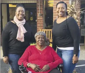 ?? Leah Burrough photo via AP ?? Bessie Burden poses with her daughters, Theresa Burrough (left) and Lashieka Mitchell outside the Westbury Conyers nursing home in Conyers, Ga., on Nov. 2019. Burden died Oct. 22, after becoming infected with the coronaviru­s during an outbreak at the nursing home. Burden’s daughters blame the home for their mother’s death, saying administra­tors kept the family in the dark about Burden being exposed to the virus and quarantine­d as a presumptiv­e case. But the state has essentiall­y blocked them from going to court.