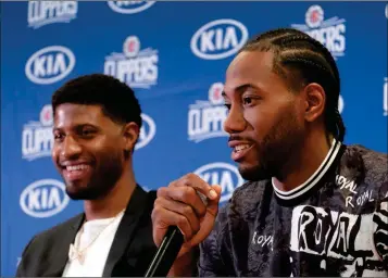  ?? ASSOCIATED PRESS ?? THE LOS ANGELES CLIPPERS introduce Paul George (left) and Kawhi Leonard at a press conference Wednesday at the Green Meadows Recreation Center in Los Angeles.