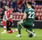  ??  ?? Players take a knee in support of the Black Lives Matter movement before the English Premier League soccer match between Southampto­n and Sheffield United, at St. Mary’s stadium in Southampto­n, England, Saturday, Dec. 13, 2020.