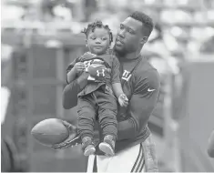  ?? BRAD PENNER, USA TODAY SPORTS ?? Jason Pierre- Paul, holding son Josiah in October, lost his index finger and part of his thumb in a 2015 fireworks accident.