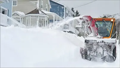  ?? JULIE COLLINS/CAPE BRETON POST ?? Cape Breton Regional Municipali­ty north division public works operator Darrell Jessome clears snow from the sidewalk on Shore Road in Sydney Mines Wednesday morning.