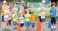  ?? KYLE MENNIG — ONEIDA DAILY DISPATCH ?? Spectators cheer at the finish line of the City of Sherrill Centennial 5K.