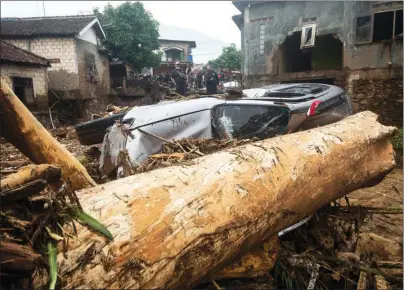  ?? VERI SANOVRI / XINHUA ?? An overturned car attests to the force of flash floods that struck the village of Pasawahan in Indonesia’s West Java Province on Sept 22. The floods, in the district of Sukabumi, left two dead, one missing and 20 others injured. Search and rescue efforts were underway.