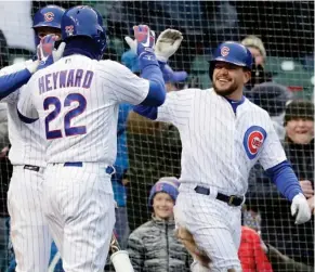  ?? Huh, AP) (Photo by Nam Y. ?? Chicago Cubs' Kyle Schwarber, right, celebrates with Jason Heyward (22) in the eighth inning of Saturday's game against the Atlanta Braves in Chicago.