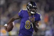  ?? KYUSUNG GONG — THE ASSOCIATED PRESS ?? Ravens quarterbac­k Lamar Jackson runs against the Rams during the first half on Monday in Los Angeles.