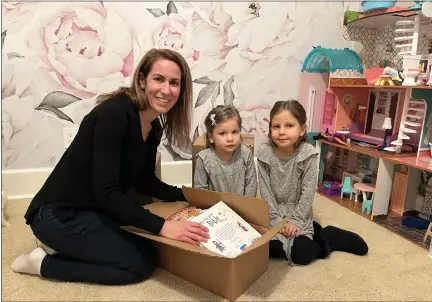  ?? PHOTO COURTESY OF KEVIN CHRISTENSE­N ?? Rachalle Christense­n, left, and her daughters, Katherine, 3, and Elizabeth, 5, pack up their books for the move. Chistensen and her husband, Kevin decided to move from Michigan to Canada to be closer to their family including Rachalle’s mother.