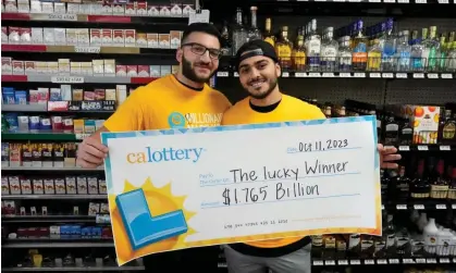  ?? Photograph: Marcio José Sánchez/AP ?? Jonathan Khalil, left, and Chris Khalil, sons of the store owners, hold up a ceremonial check.