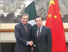  ?? KUANG LINHUA / CHINA DAILY ?? State Councilor and Foreign Minister Wang Yi greets Pakistani Foreign Minister Shah Mahmood Qureshi as they co-host the first China-Pakistan Foreign Ministers’ Strategic Dialogue in Beijing on Tuesday.