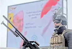  ?? — AFP photo ?? A member of Iraq’s security forces keep watch in Baghdad, hours before the start of Pope Francis’ first visit to Iraq.