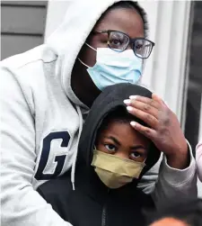  ??  ?? HARD TO COPE: Family members look on during the vigil Sunday for Delois Brown.