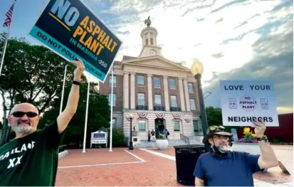  ?? STEVEN PORTER/GLOBE STAFF ?? Paul Pederzani (left) and Doug Wilcox protested prior to the Planning Board meeting.