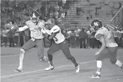  ?? Staff photo by Joshua Boucher ?? n Hooks’ Montrell Estell fends off Paul Pewitt’s Tyshun Mitchell on Oct. 21, 2016, at Hooks High School.