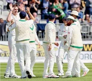  ?? — AFP ?? Ireland’s Boyd Rankin (left) celebrates with teammates after taking the wicket of Pakistan’s Asad Shafiq in Dublin on Saturday.