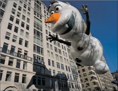  ?? The Associated Press ?? BUILD A SNOWMAN: The Olaf balloon glides over Central Park West on Thursday during the Macy’s Thanksgivi­ng Day Parade in New York.