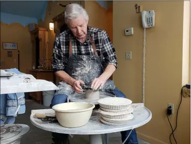  ?? ZACHARY SRNIS — THE MORNING JOURNAL ?? Joe Filipiak, the artist from Hawk’s Nest Art Studio in Grafton Township, makes pottery using a hand wheel.