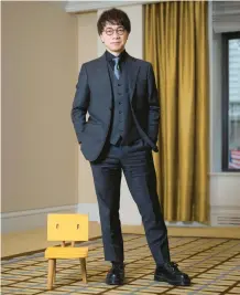  ?? MATT LICARI/INVISION ?? Filmmaker Makoto Shinkai stands with a three-legged chair March 28 in New York.