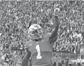  ??  ?? Ohio State wide receiver Johnnie Dixon celebrates after scoring a touchdown against Michigan on Saturday in Columbus, Ohio.