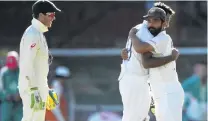  ?? PHOTO: GETTY IMAGES ?? Australia’s captain Tim Paine watches on as India’s Ravichandr­an Ashwin embraces his captain, Ajinkya Rahane, as they celebrate securing a draw on day five of the third test at the Sydney Cricket Ground yesterday.