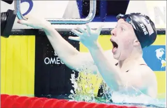  ??  ?? Lilly King of the U.S. reacts after breaking the world record.