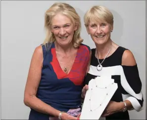  ??  ?? Ros Sparks, a prize winner in the Lady Captain’s Prize competitio­n at Blainroe Golf Club, receives her prize from Lady Captain Tina Meehan.