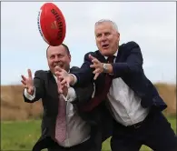  ??  ?? Treasurer Josh Frydenberg, left, and Deputy Prime Minister Michael Mccormack compete to catch a football at a community funding announceme­nt in Melbourne