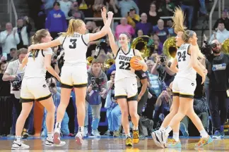  ?? ASSOCIATED PRESS ?? Iowa guard Caitlin Clark (22) celebrates with teammates after defeating LSU in an Elite Eight round college basketball game during the NCAA Tournament, Monday, April 1, 2024, in Albany, N.Y.