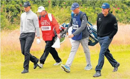  ?? KEVIN C. COX/GETTY IMAGES ?? Henrik Stenson, left, and his caddie, Gareth Lord, walk with Phil Mickelson and his caddie, Jim McKay, at Royal Troon. Mickelson, 46, hasn’t won since the British Open in 2013; Stenson, 40, won last month in the European Tour’s BMW Internatio­nal Open.