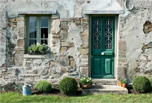  ??  ?? nd
FRONT ENTRANCE Annie found the front door, which was already painted green, at a salvage shop. “One day the paint will start falling off, but I love the way it looks now,” she says. COUNTRY RETREAT Before Covid-19, the rustic home in France was the perfect place for family to gather, including the couple’s sons and grandchild­ren.