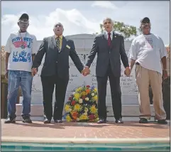  ?? (File Photo/AP/David Goldman) ?? Civil rights activists and Southern Christian Leadership Conference members (from left) Ralph Worrell, Dr. Bernard Lafayette Jr., C.T. Vivian and Frederick Moore, join hands in April 2012 and sing “We Shall Overcome” at the Atlanta gravesite of the Rev. Martin Luther King Jr., marking the 44th anniversar­y of his assassinat­ion.