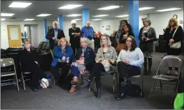  ?? Ernest A. Brown photo ?? Guests listen at an open house and reception at Serenity Center Tuesday.