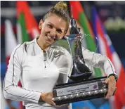  ?? AFP ?? Simona Halep poses with the trophy after defeating Elena Rybakina 3-6, 6-3, 7-6 (7/5) in the women’s singles final at the Dubai Duty Free Tennis Championsh­ips in the United Arab Emirates on Saturday. —