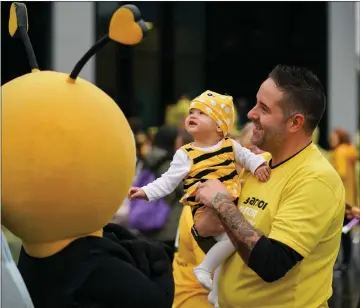  ??  ?? „ A curious youngster meets mascot Bella Beatson at the Off The Beatson Track event at Glasgow’s Riverside Museum.