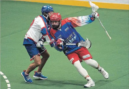  ?? JESSICA NYZNIK EXAMINER ?? Peterborou­gh Century 21 Lakers Adam Jones tries to get past Mapleridge Burrards Colton Porter during Game 1 of the Mann Cup at the Memorial Centre on Friday night. Jones scored the winning goal for the Lakers in a 14-13 double overtime thriller. Game 2 is Saturday at 7 p.m. at the PMC.